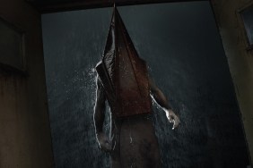 Silent Hill 2 Remake: Pyramid Head stood at an open door with rain pouring down outside.